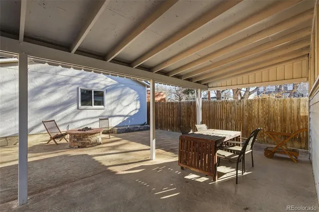 a patio with table and chairs