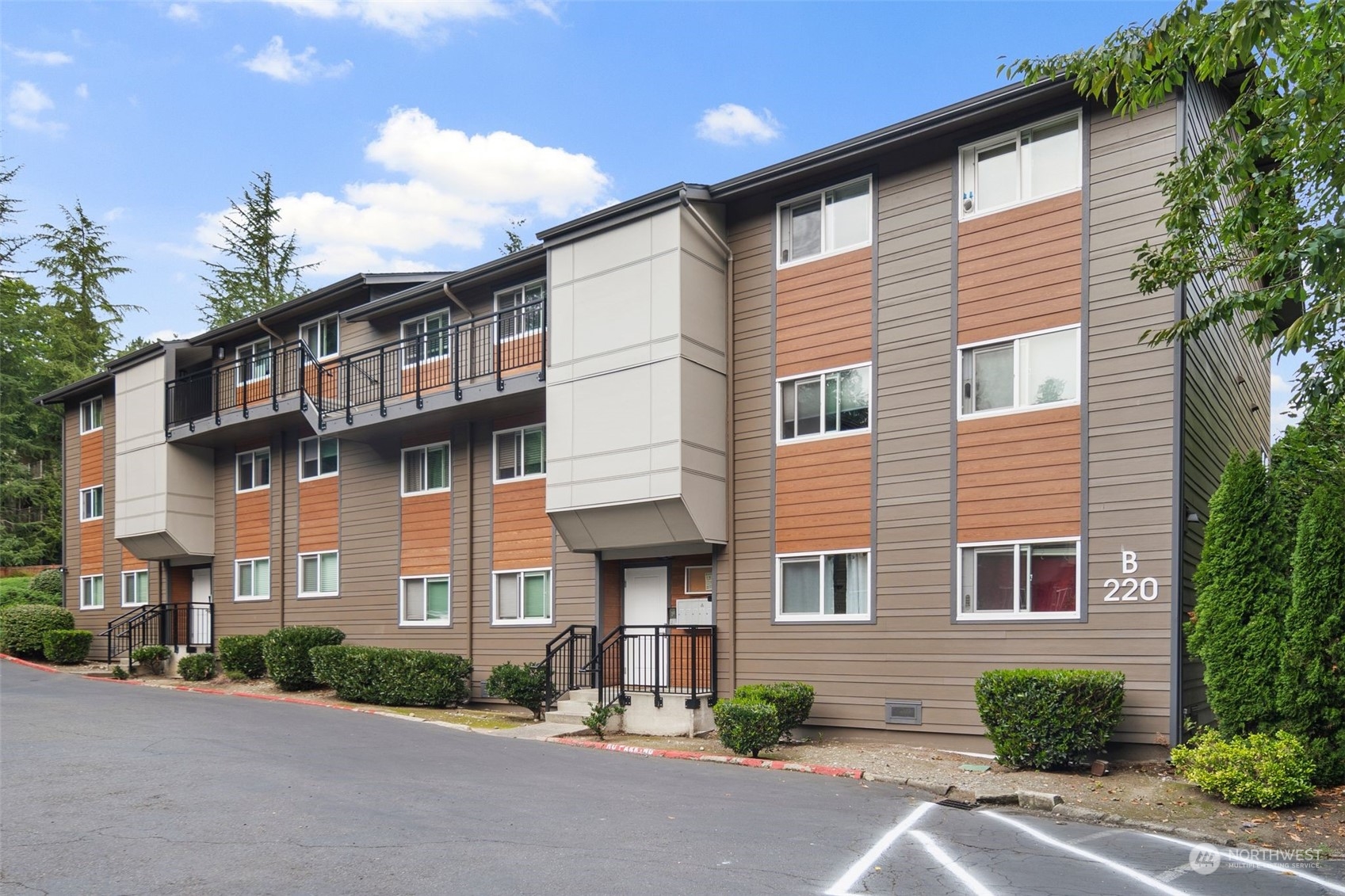 220 Southwest Clark Street, Unit B302 Issaquah, WA 98027 - Photo 1 of 20 a front view of a house with a yard