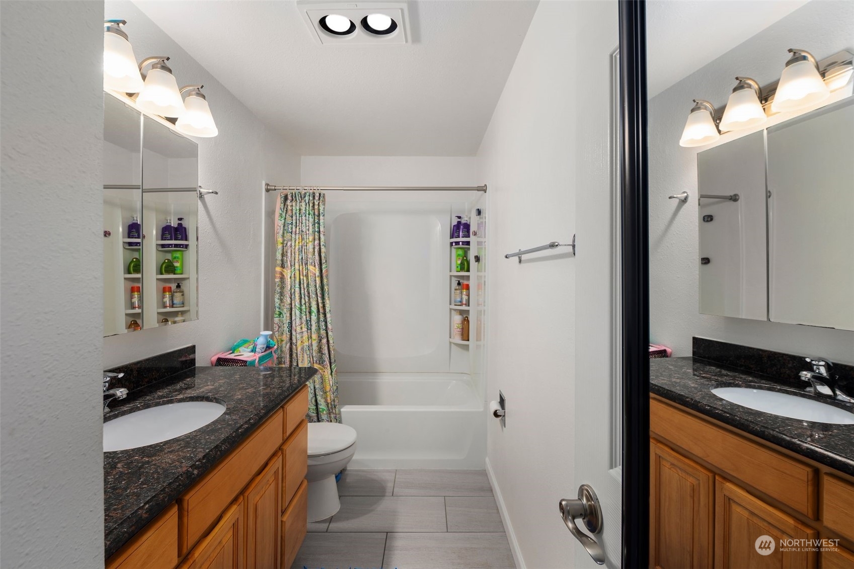 220 Southwest Clark Street, Unit B302 Issaquah, WA 98027 - Photo 17 of 20 a bathroom with a granite countertop sink toilet and shower