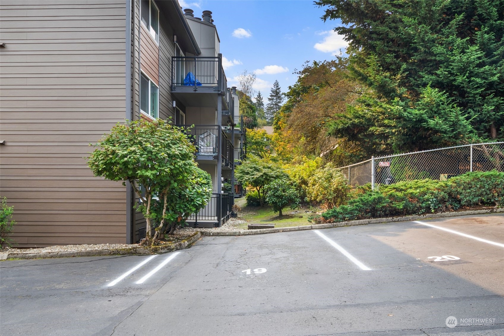 220 Southwest Clark Street, Unit B302 Issaquah, WA 98027 - Photo 19 of 20 a yellow house with trees in front of it