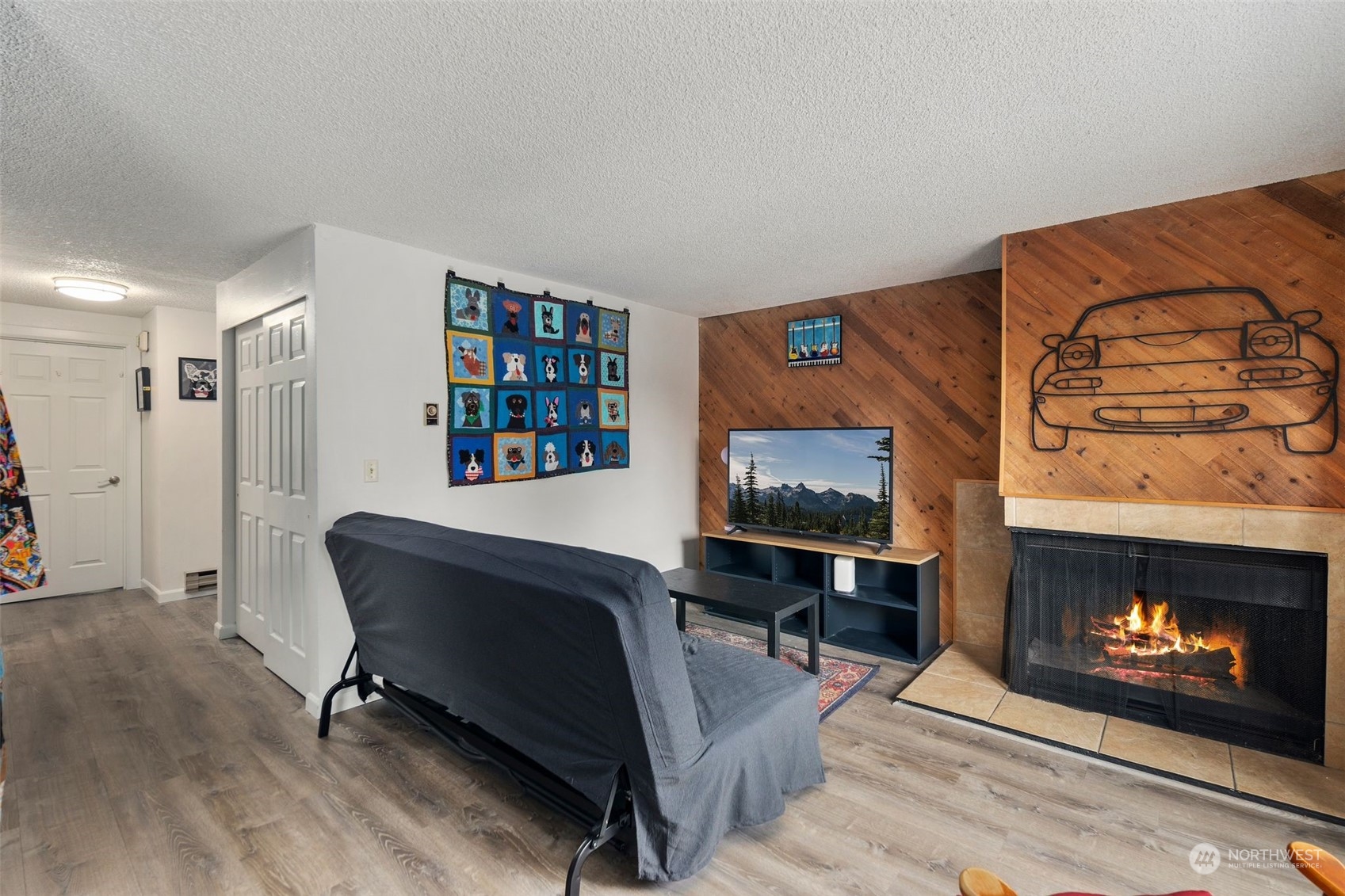 220 Southwest Clark Street, Unit B302 Issaquah, WA 98027 - Photo 6 of 20 a living room with furniture a fireplace and a flat screen tv