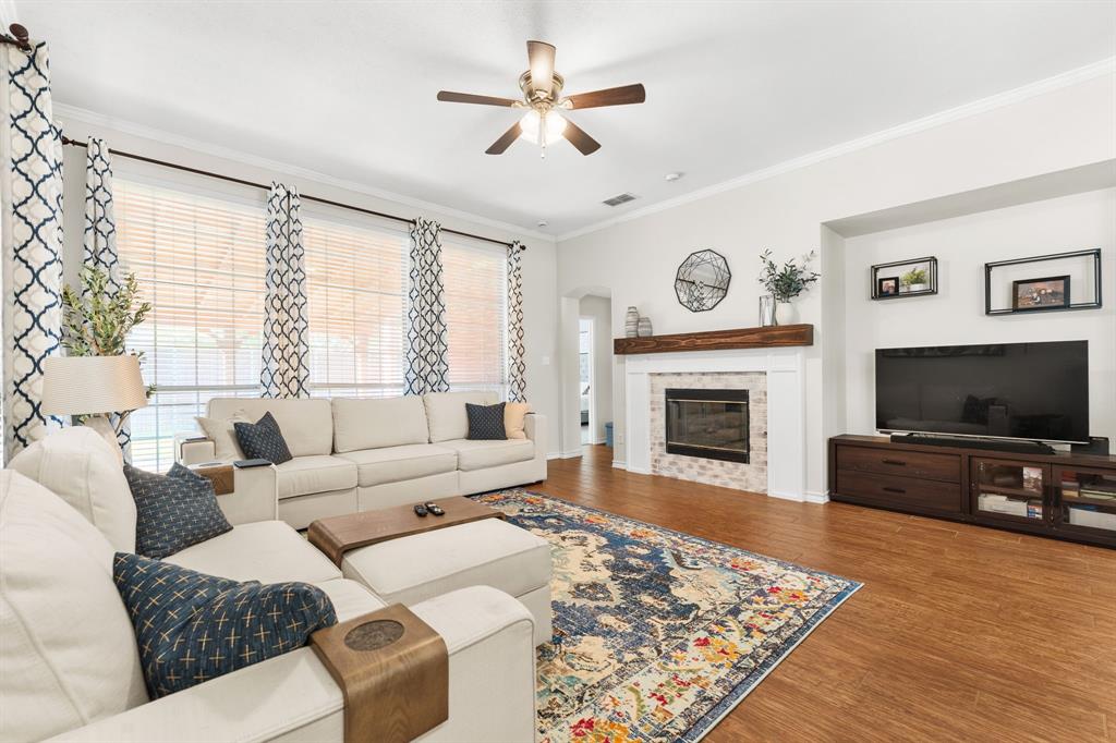 7321 Summit View Lane Sachse, TX 75048 - Photo 11 of 28 a living room with furniture a flat screen tv and a fireplace
