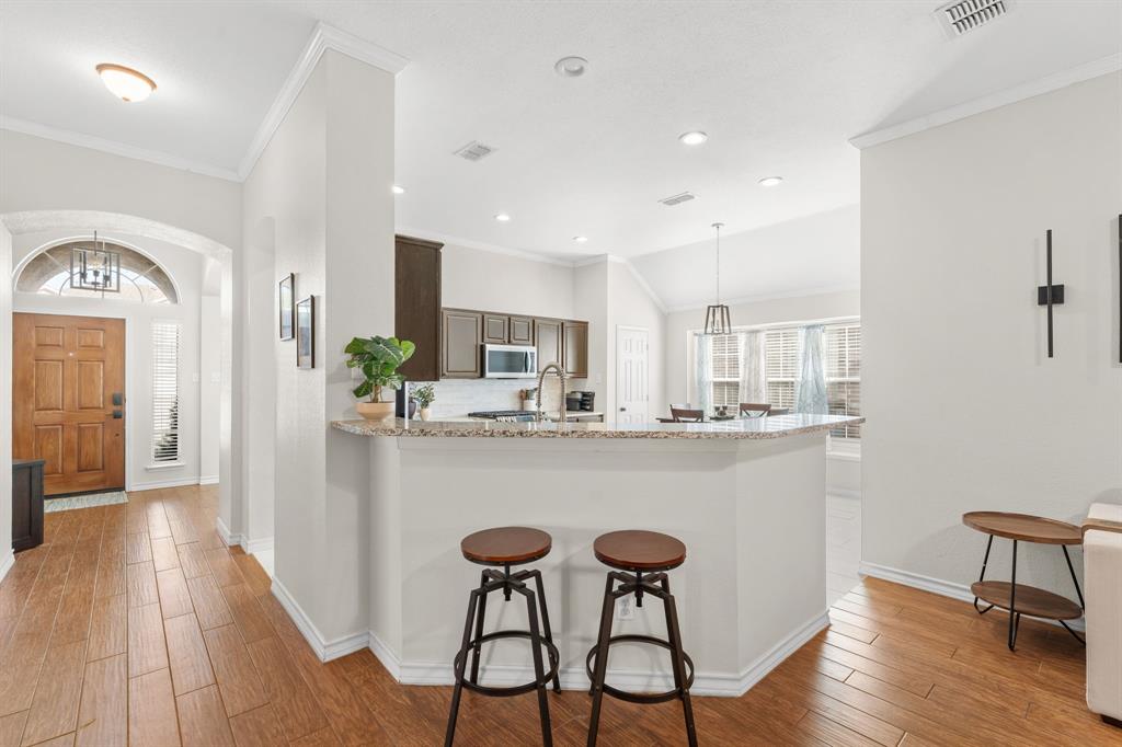 7321 Summit View Lane Sachse, TX 75048 - Photo 14 of 28 a kitchen with a table and chairs in it