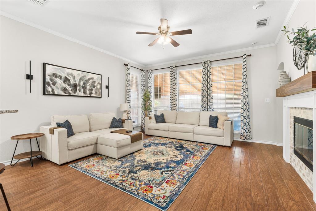 7321 Summit View Lane Sachse, TX 75048 - Photo 16 of 28 a living room with furniture large window and a fireplace
