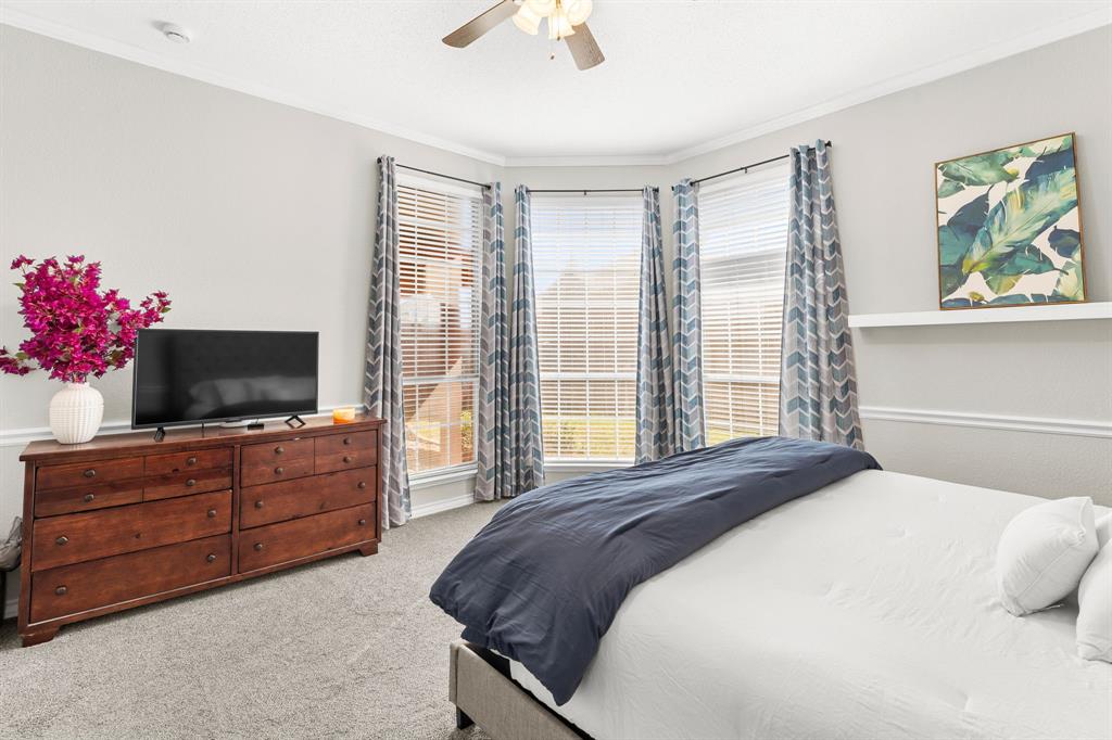 7321 Summit View Lane Sachse, TX 75048 - Photo 18 of 28 a bedroom with a bed and a flat screen tv