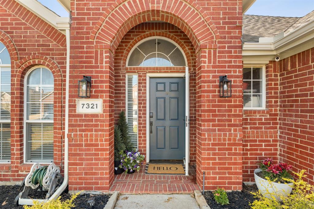 7321 Summit View Lane Sachse, TX 75048 - Photo 2 of 28 a front view of a brick house with a outdoor space