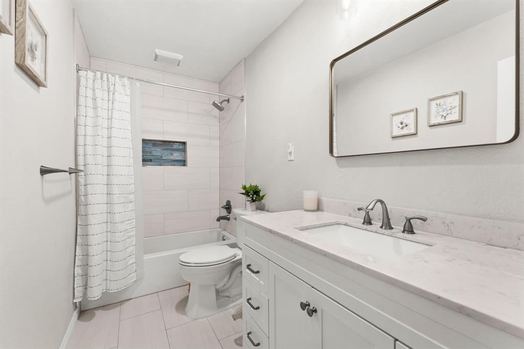 7321 Summit View Lane Sachse, TX 75048 - Photo 25 of 28 a bathroom with a sink a toilet and shower