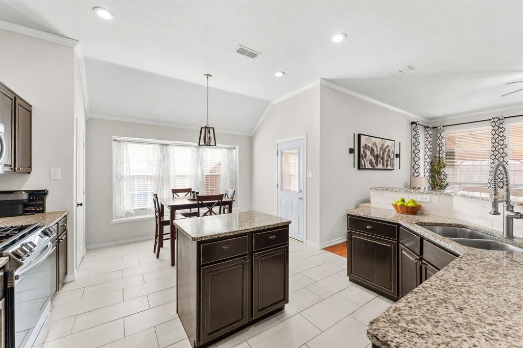 7321 Summit View Lane Sachse, TX 75048 - Photo 6 of 28 a kitchen with stainless steel appliances granite countertop a stove top oven a sink a counter space and cabinets