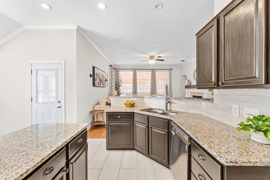 7321 Summit View Lane Sachse, TX 75048 - Photo 7 of 28 a kitchen with stainless steel appliances granite countertop a sink stove and cabinets