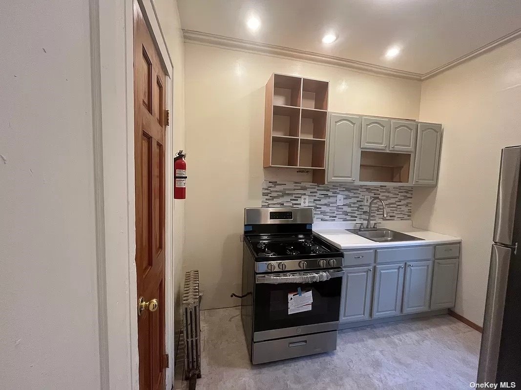 a kitchen with stainless steel appliances a stove and a refrigerator