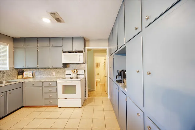 a kitchen with a sink cabinets and appliances