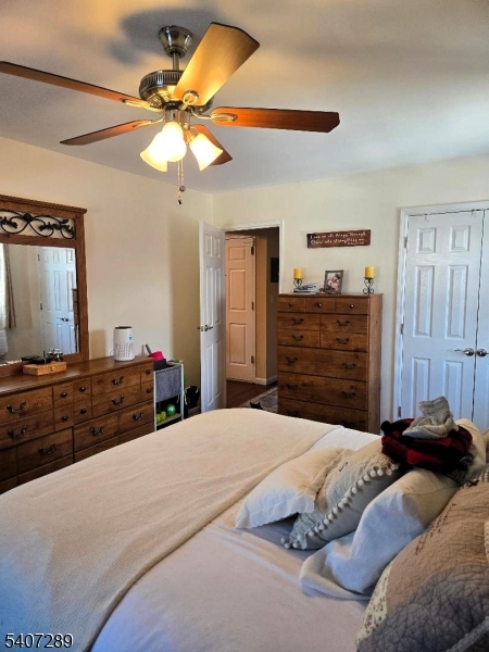 19 Savage Road Denville, NJ 07834 - Photo 16 of 20 a bedroom with a bed and a chandelier