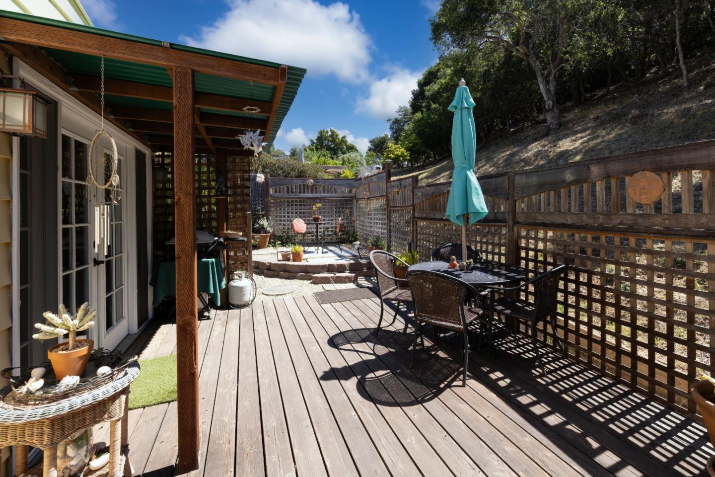 270 Hames Road, Unit 16 Corralitos, CA 95076 - Photo 3 of 20 a view of a patio with table and chairs wooden floor and fence