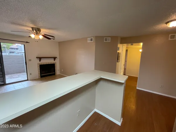 a view of a livingroom with a ceiling fan and window