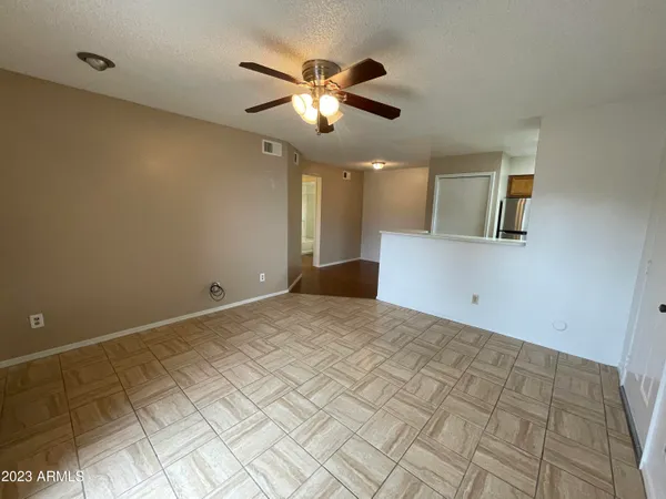 a view of empty room with ceiling fan