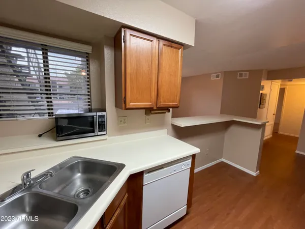 a kitchen with a refrigerator a sink and cabinets