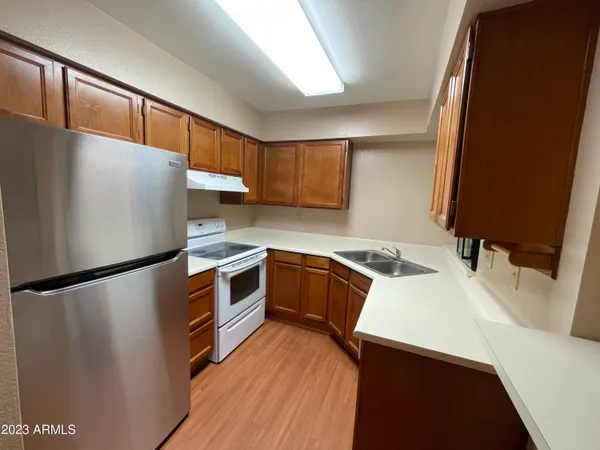 a view of kitchen with furniture and a refrigerator