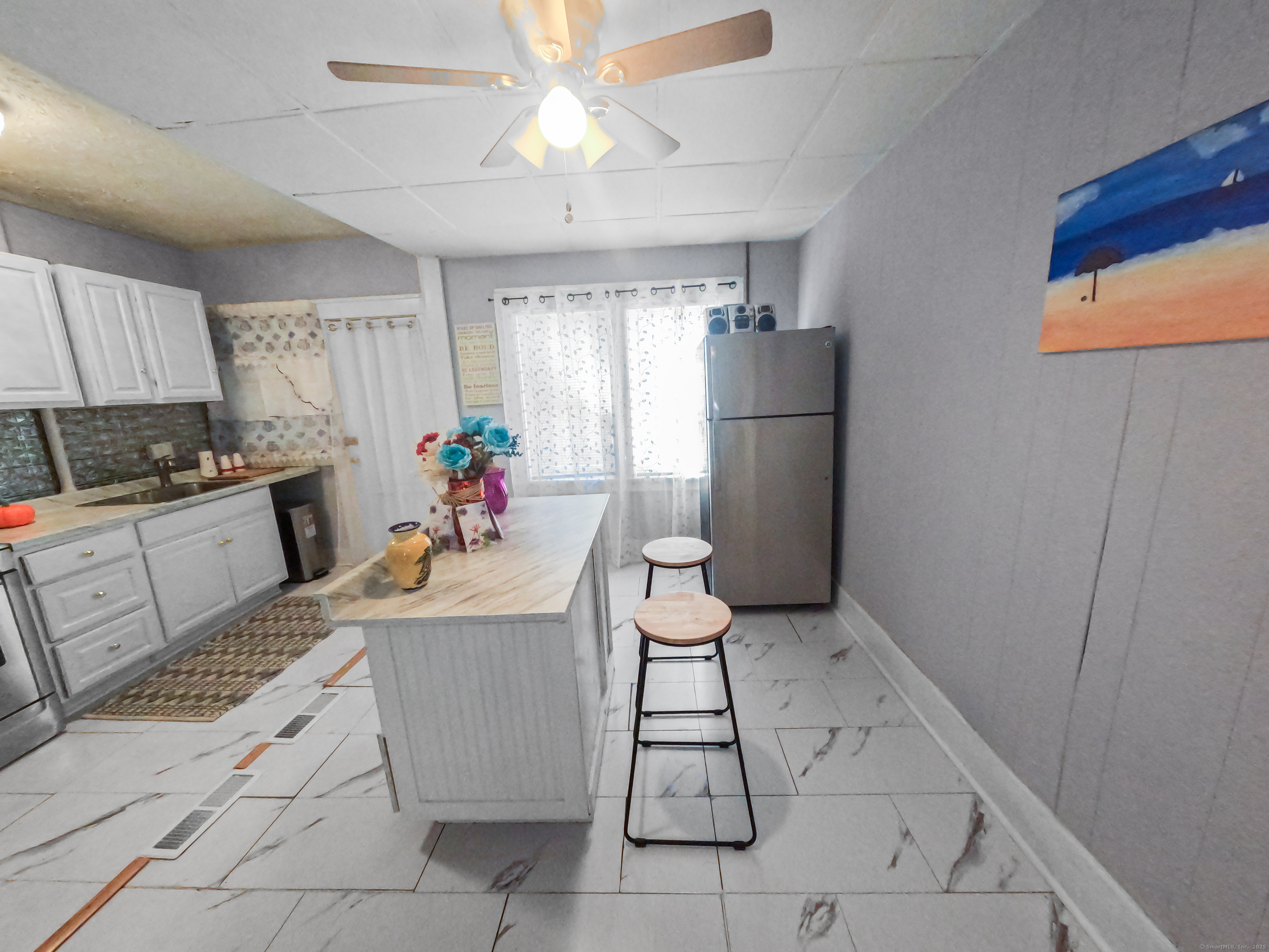 Undisclosed Address Waterbury, CT 06704 - Photo 12 of 36 a kitchen with a sink a refrigerator and a stove top oven