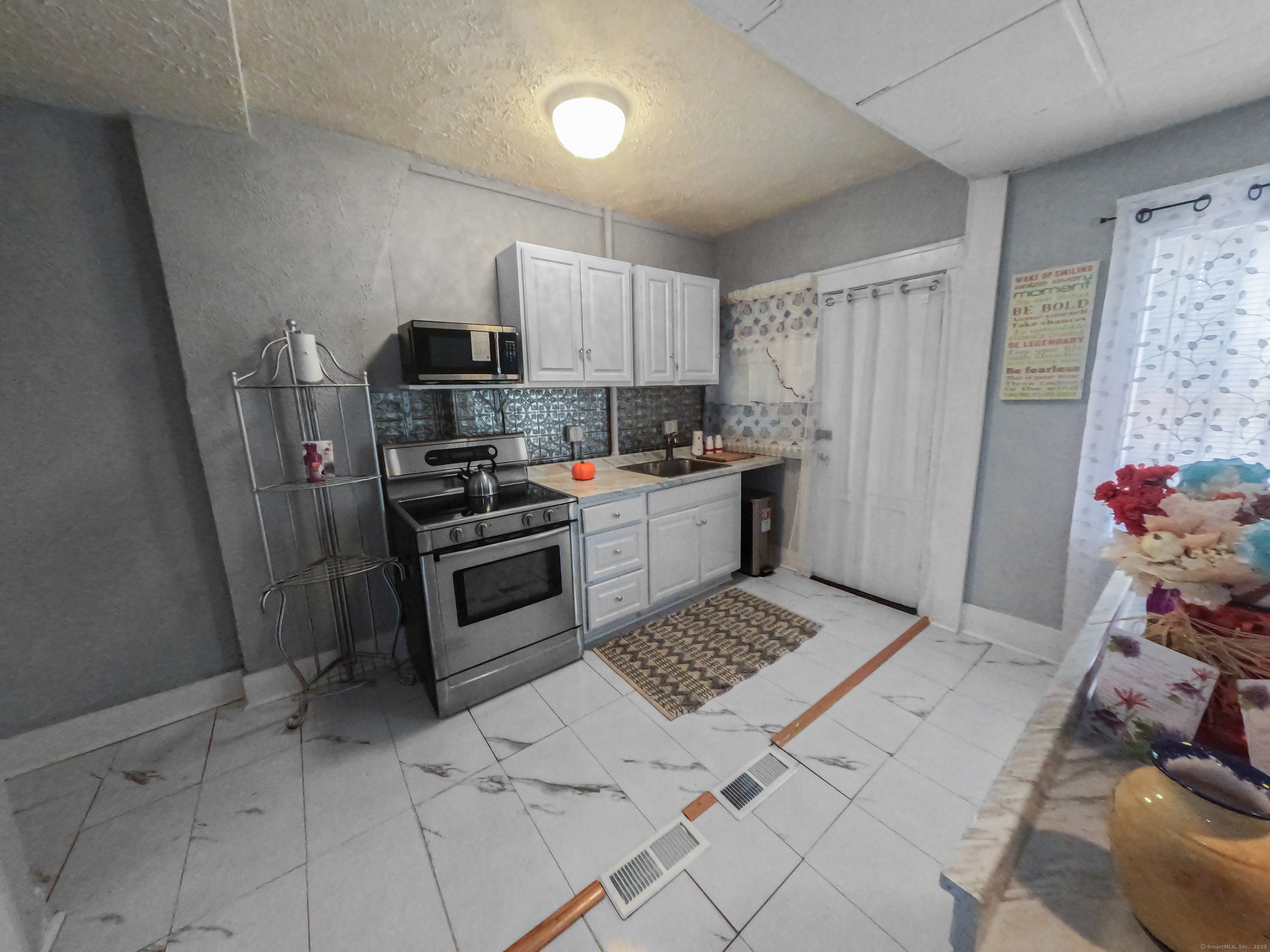 Undisclosed Address Waterbury, CT 06704 - Photo 13 of 36 a kitchen with a sink a stove and refrigerator