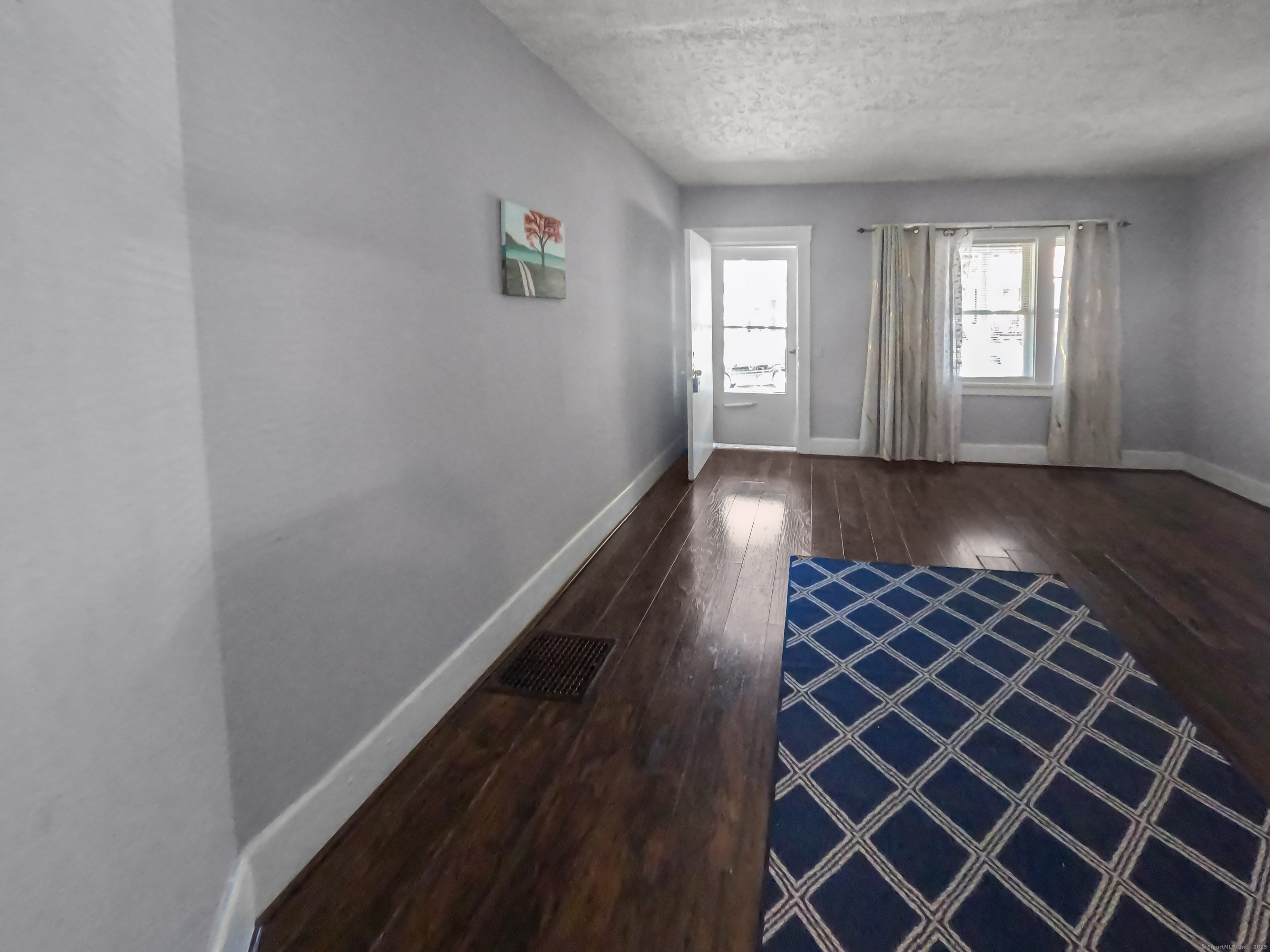 Undisclosed Address Waterbury, CT 06704 - Photo 16 of 36 an empty room with wooden floor and windows