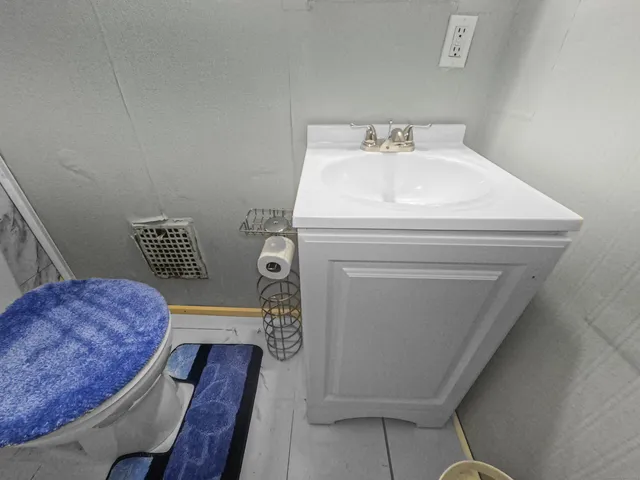 a bathroom with a toilet and a shower