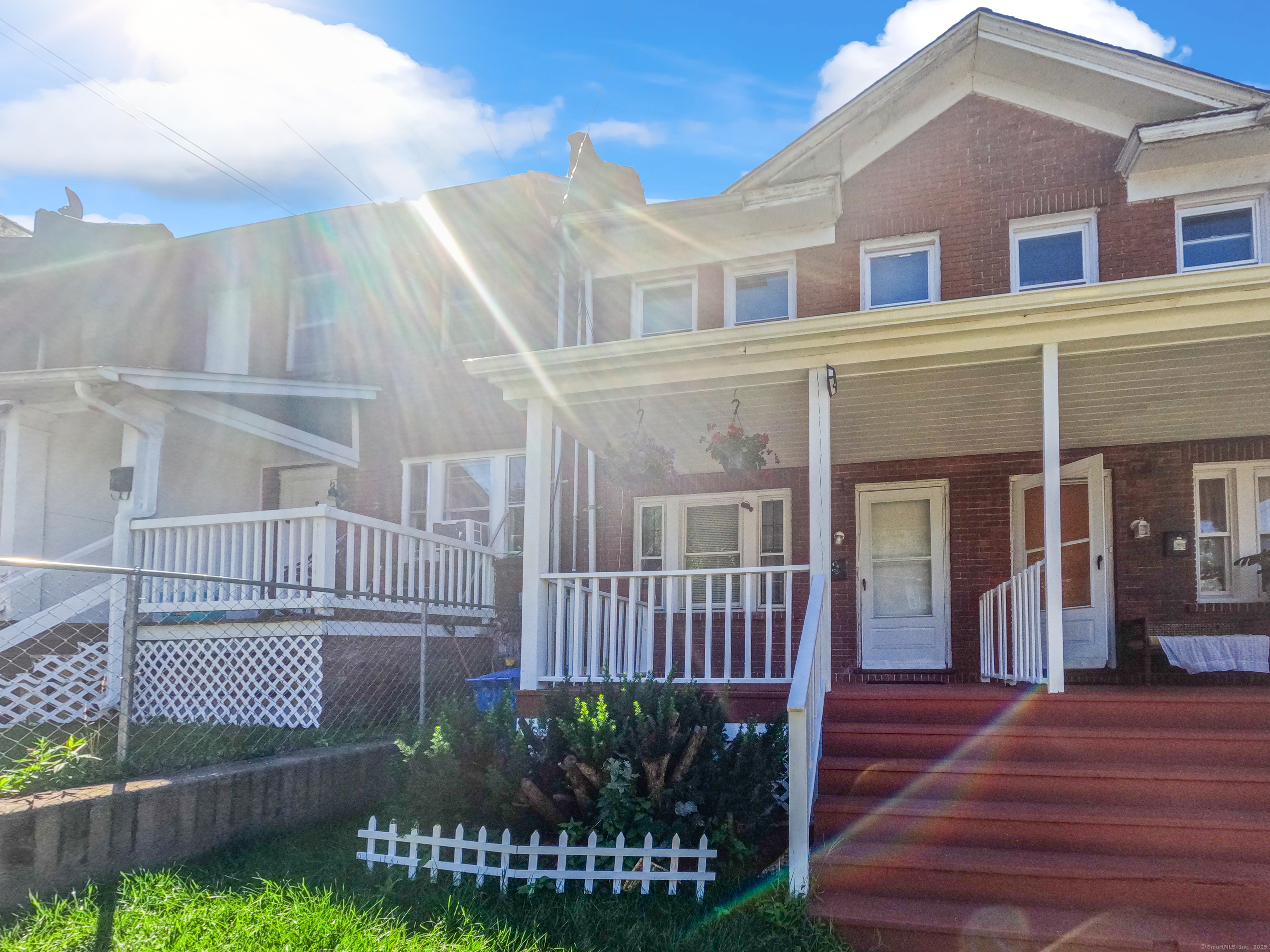 Undisclosed Address Waterbury, CT 06704 - Photo 2 of 36 a view of a brick house with many windows next to a yard