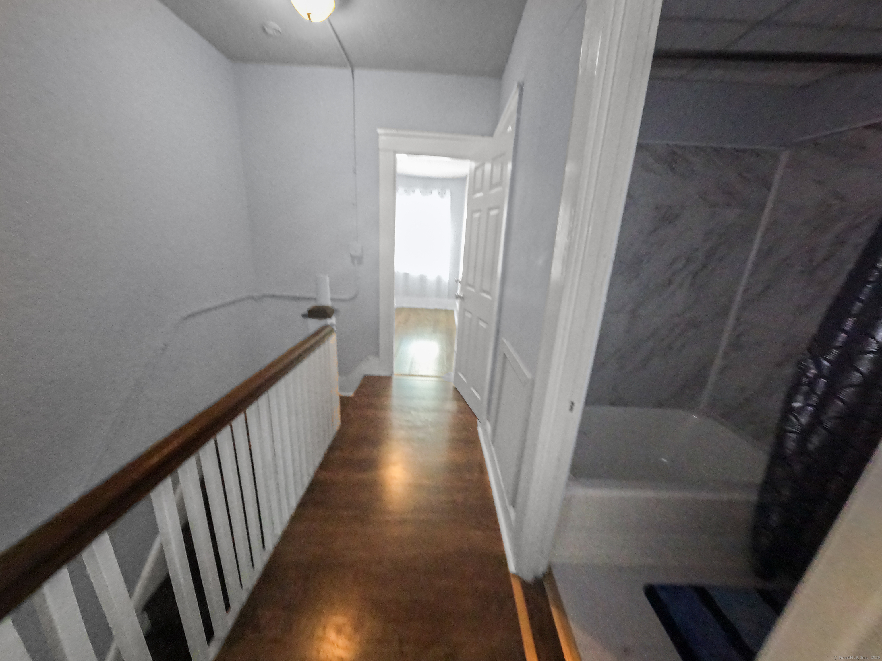 Undisclosed Address Waterbury, CT 06704 - Photo 22 of 36 a view of a hallway with wooden floor and staircase