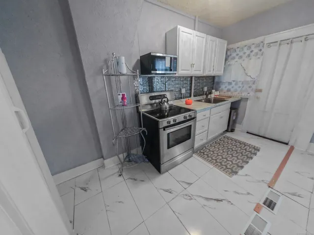 a kitchen with a sink and cabinets