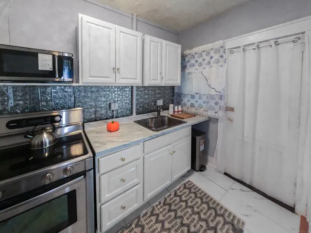 a kitchen with a stove and a microwave