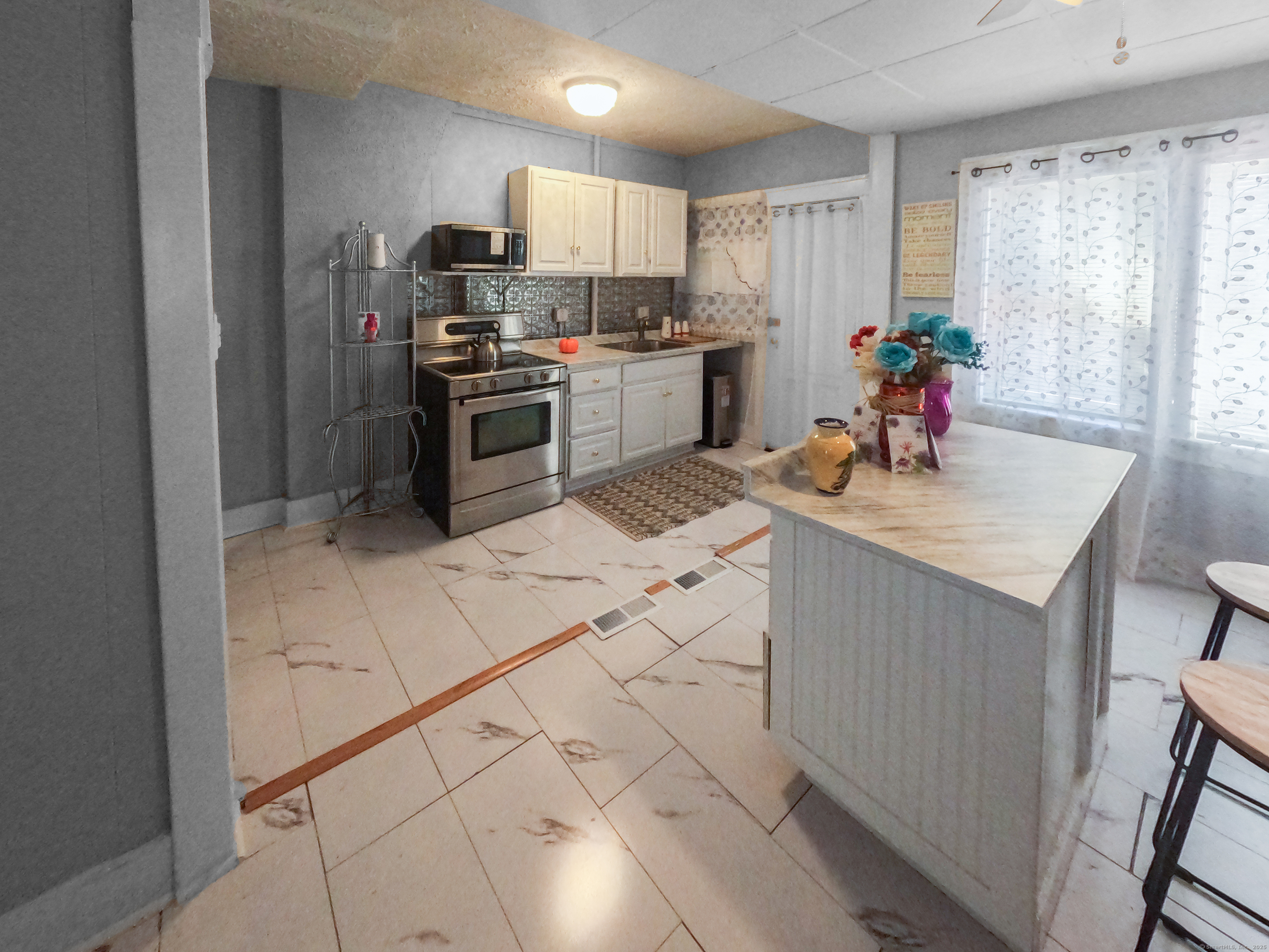 Undisclosed Address Waterbury, CT 06704 - Photo 9 of 36 a kitchen with stainless steel appliances a sink stove refrigerator and cabinets
