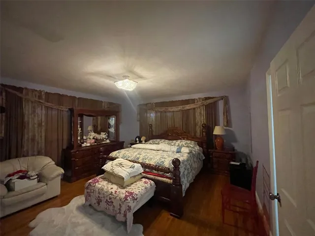 a bedroom with bed and window