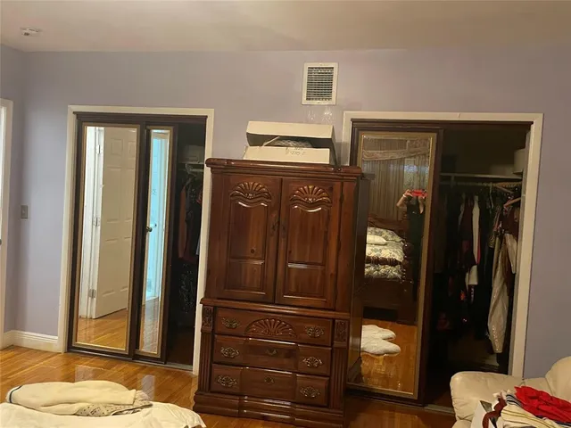 a living room with a dresser and a mirror