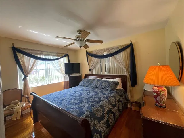 a bedroom with a bed and dresser with mirror