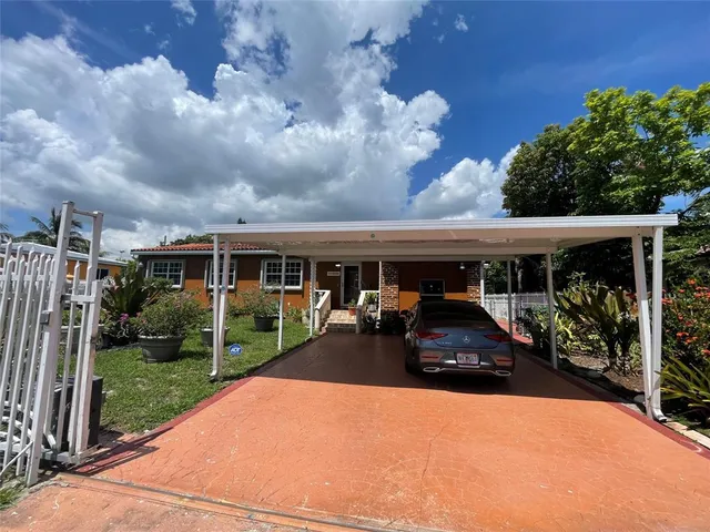 a front view of house and yard with green space