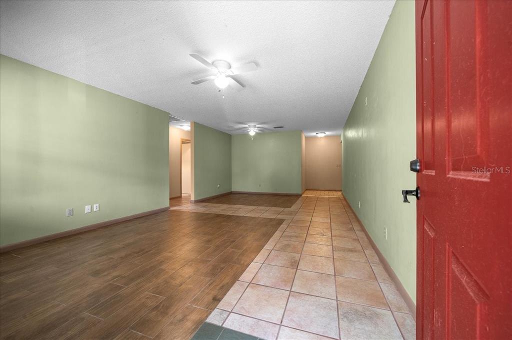 9152 Southwest 89th Terrace, Unit D Ocala, FL 34481 - Photo 16 of 39 a view of a hallway with a chandelier
