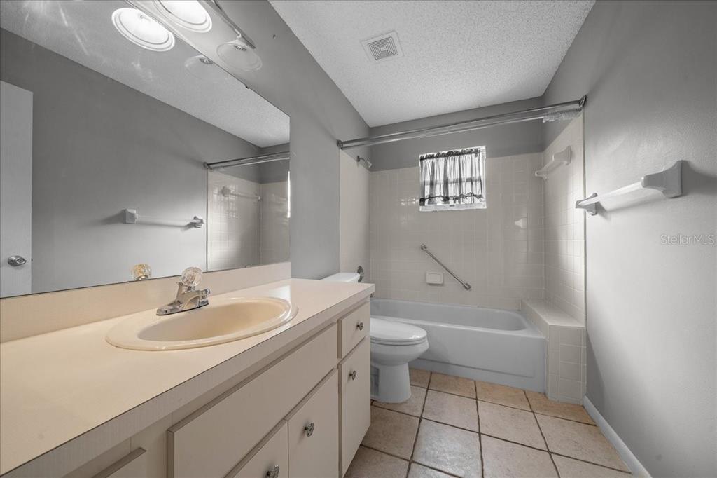 9152 Southwest 89th Terrace, Unit D Ocala, FL 34481 - Photo 25 of 39 a bathroom with a sink a toilet and shower