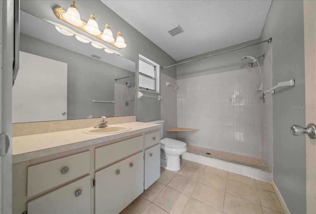9152 Southwest 89th Terrace, Unit D Ocala, FL 34481 - Photo 30 of 39 a spacious bathroom with a double vanity sink mirror and toilet
