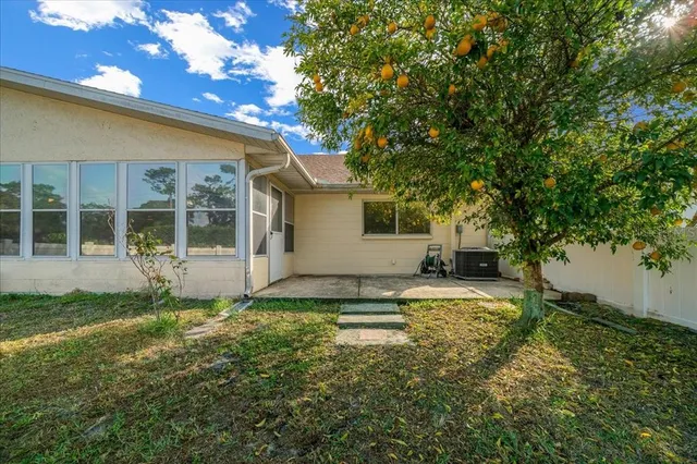 a view of a house with backyard and sitting area