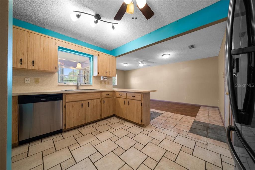 9152 Southwest 89th Terrace, Unit D Ocala, FL 34481 - Photo 33 of 39 a kitchen with a sink a stove cabinets and counter space