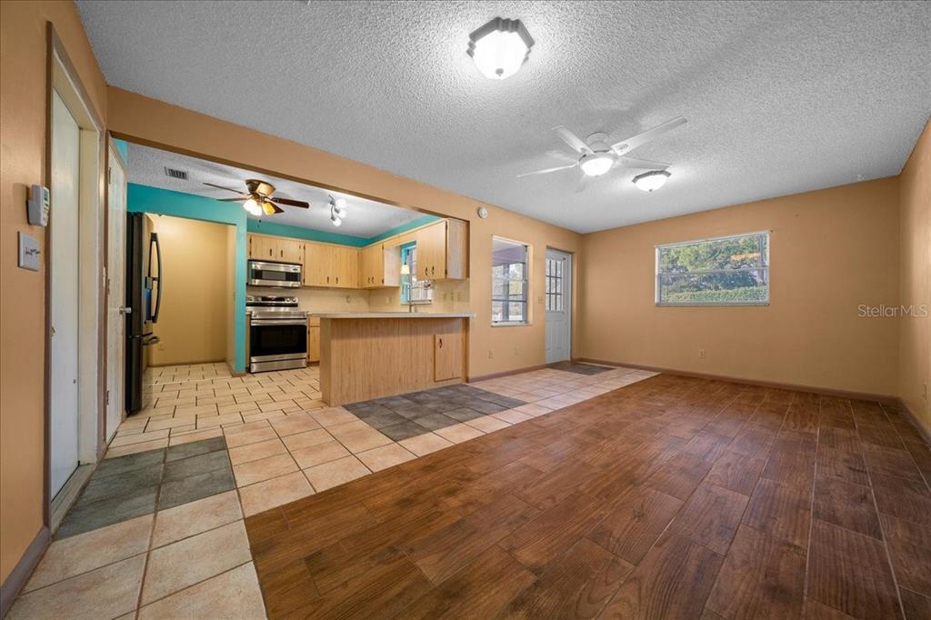9152 Southwest 89th Terrace, Unit D Ocala, FL 34481 - Photo 37 of 39 a kitchen with stainless steel appliances granite countertop a refrigerator and a stove top oven
