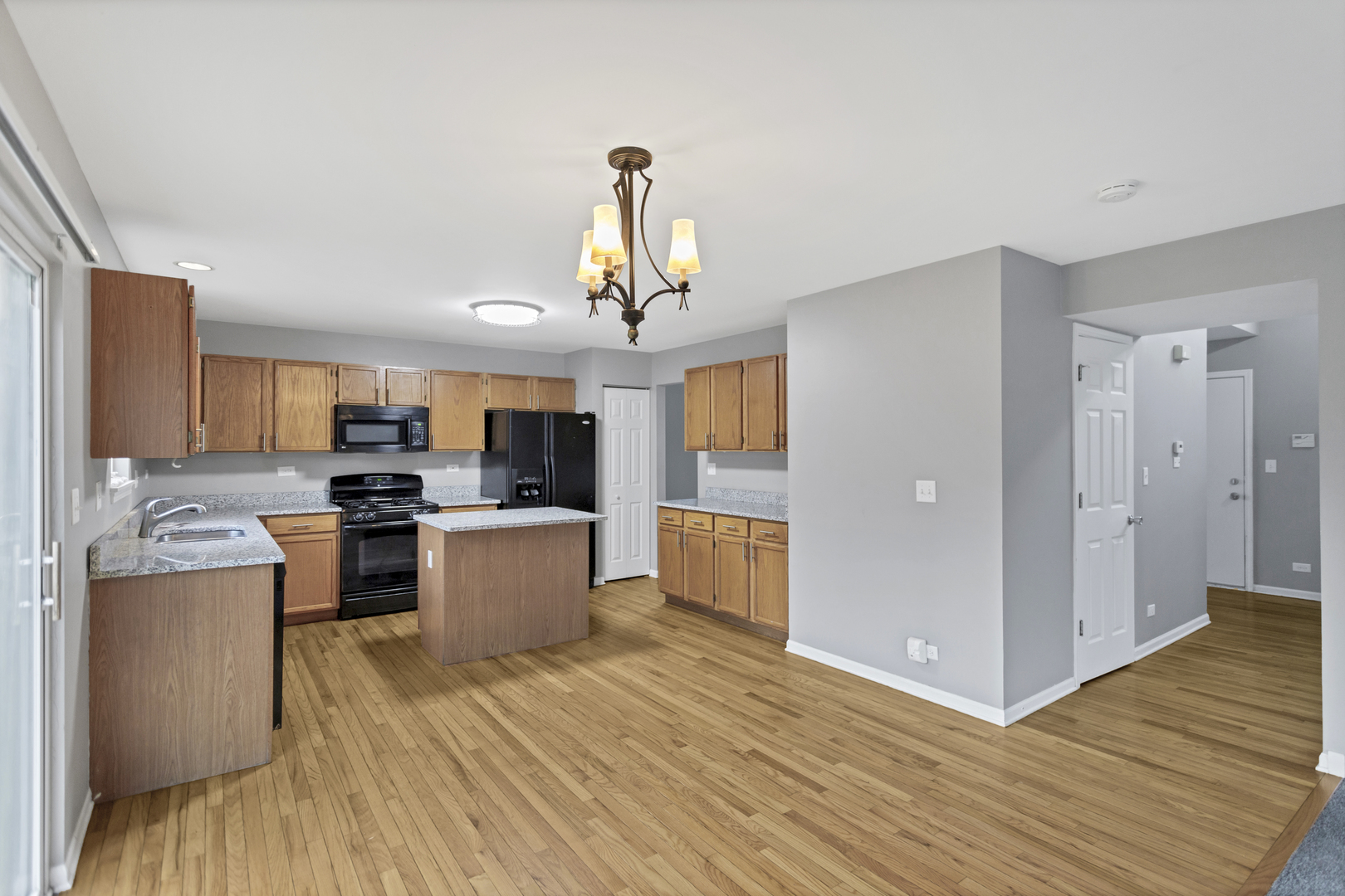 85 Old Post Road Oswego, IL 60543 - Photo 12 of 38 a view of kitchen with cabinets and wooden floor