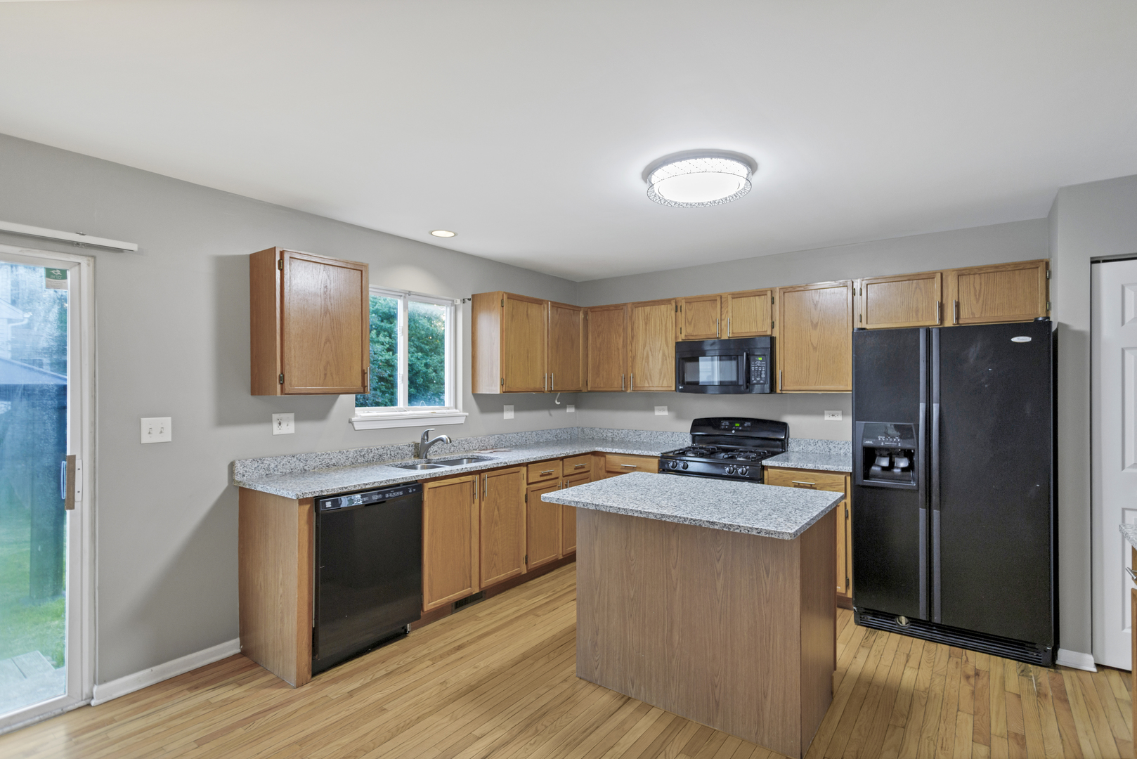 85 Old Post Road Oswego, IL 60543 - Photo 14 of 38 a kitchen with a sink stove and refrigerator