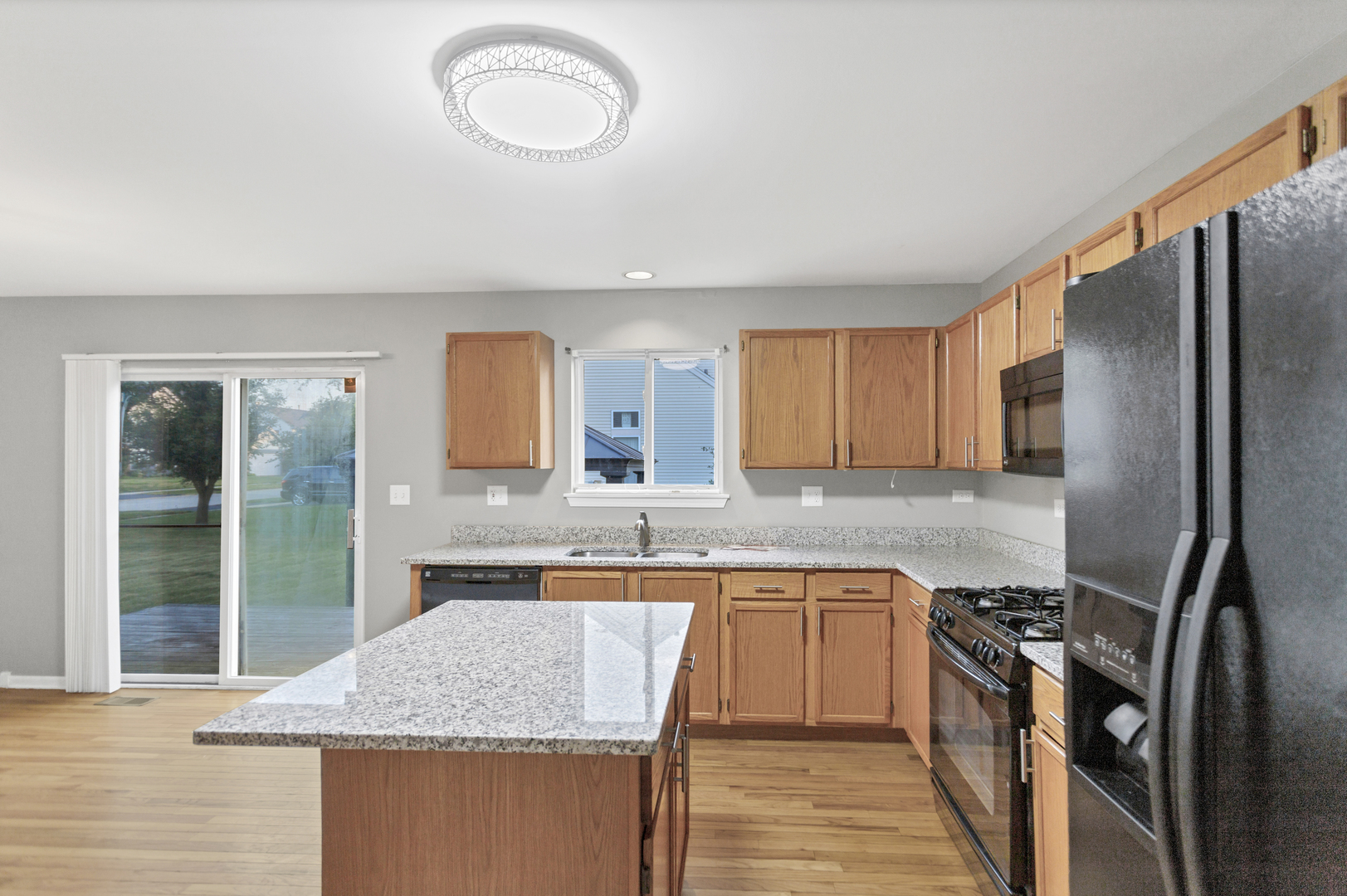 85 Old Post Road Oswego, IL 60543 - Photo 15 of 38 a kitchen with stainless steel appliances granite countertop a sink stove and refrigerator