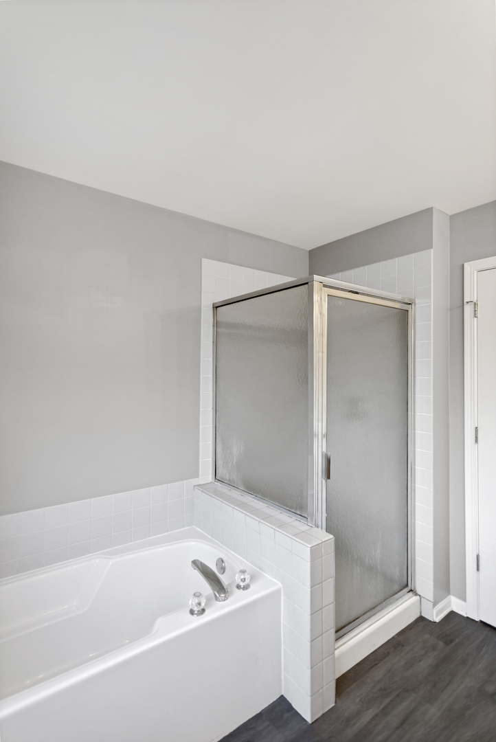 85 Old Post Road Oswego, IL 60543 - Photo 23 of 38 a bathroom with a bathtub and a shower