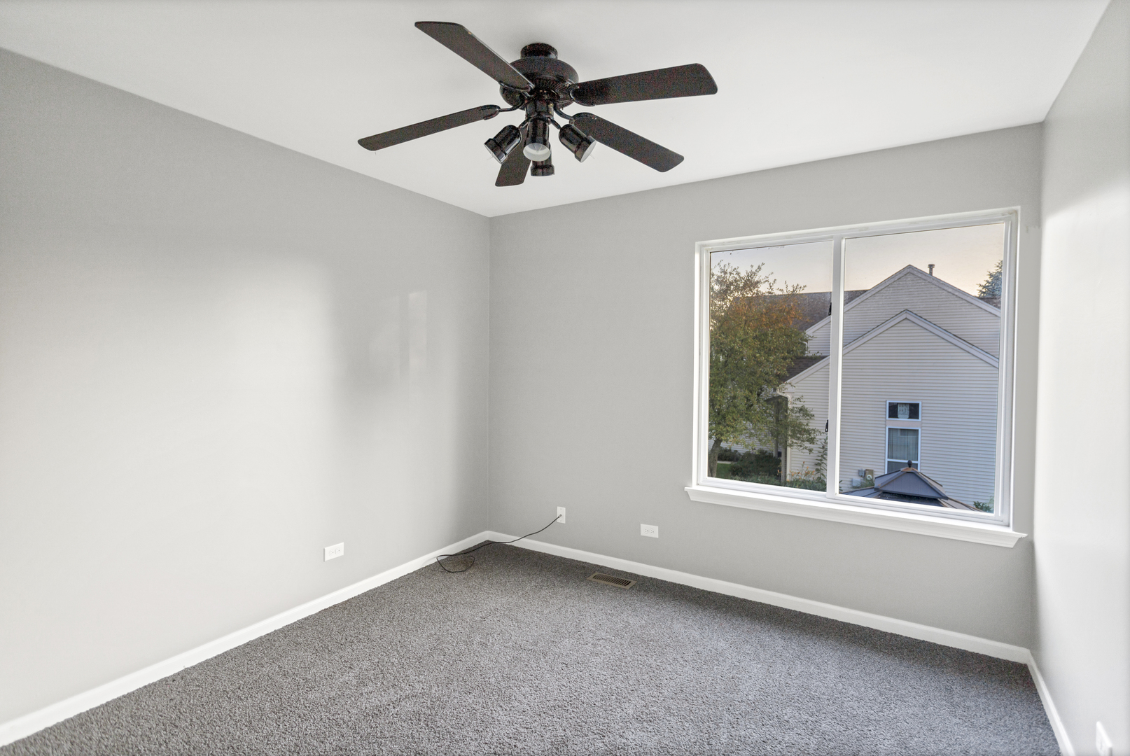 85 Old Post Road Oswego, IL 60543 - Photo 24 of 38 an empty room with a window and a fan