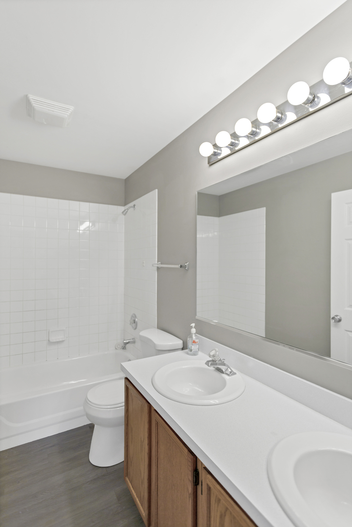 85 Old Post Road Oswego, IL 60543 - Photo 30 of 38 a bathroom with a sink a toilet and a large mirror