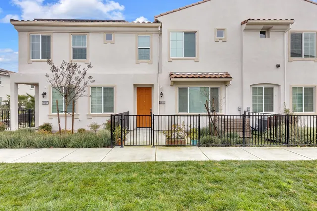 a view of a house with a small yard and plants