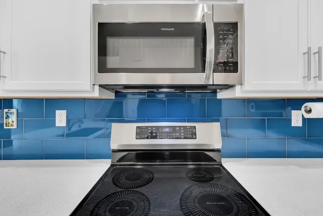 a stove top oven sitting inside of a kitchen
