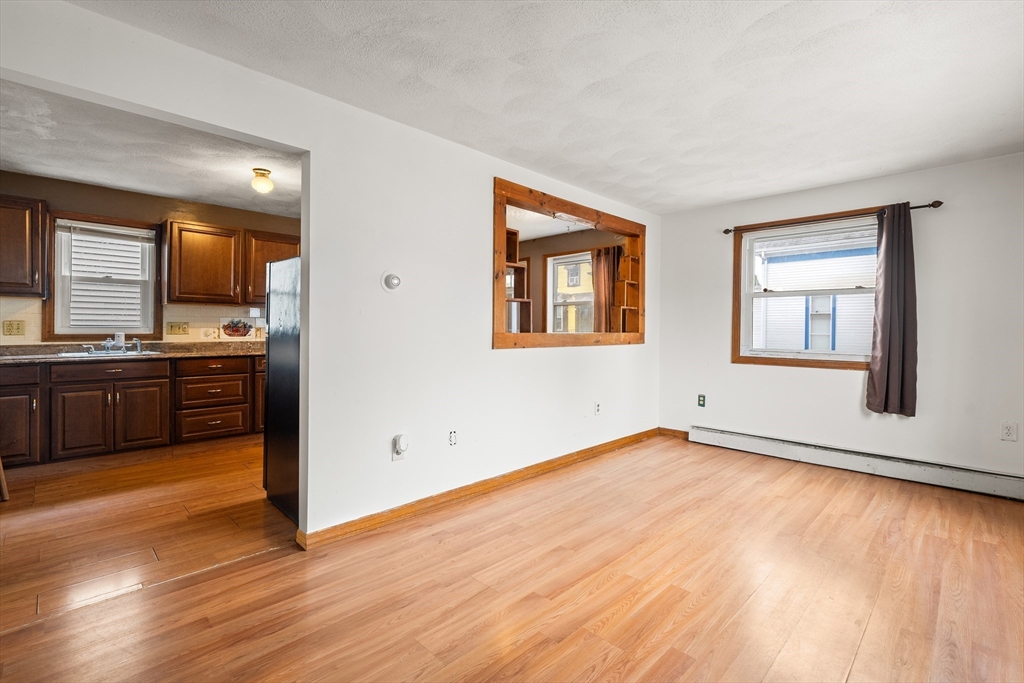 23 Logan Street Lynn, MA 01902 - Photo 10 of 27 a view of a kitchen with wooden floor and a window