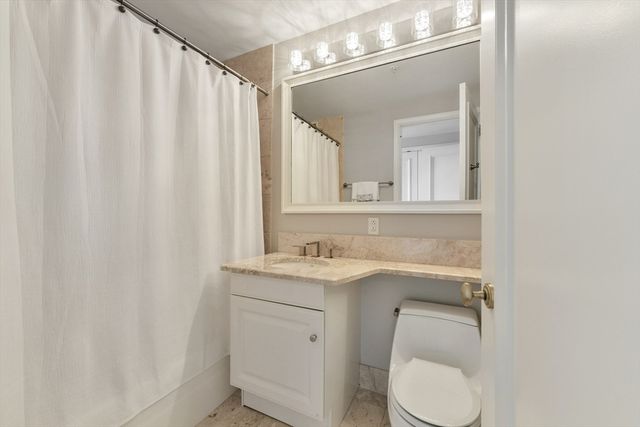 a bathroom with a toilet a sink and a mirror